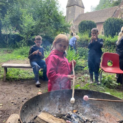 Pupils toasting marshmallows over the open fire