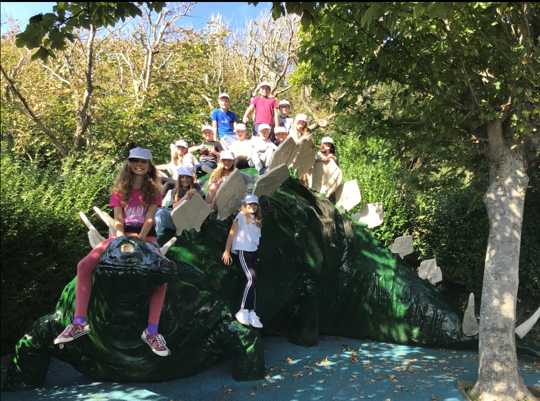 Our year 6 pupils sitting on a dinosaur on their trip to the Isle of Wight 