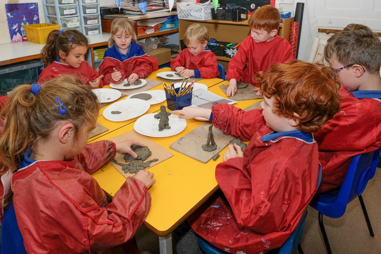 Early years pupils making clay models